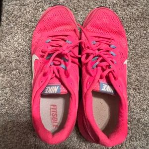 Bright pink nike athletic shoe